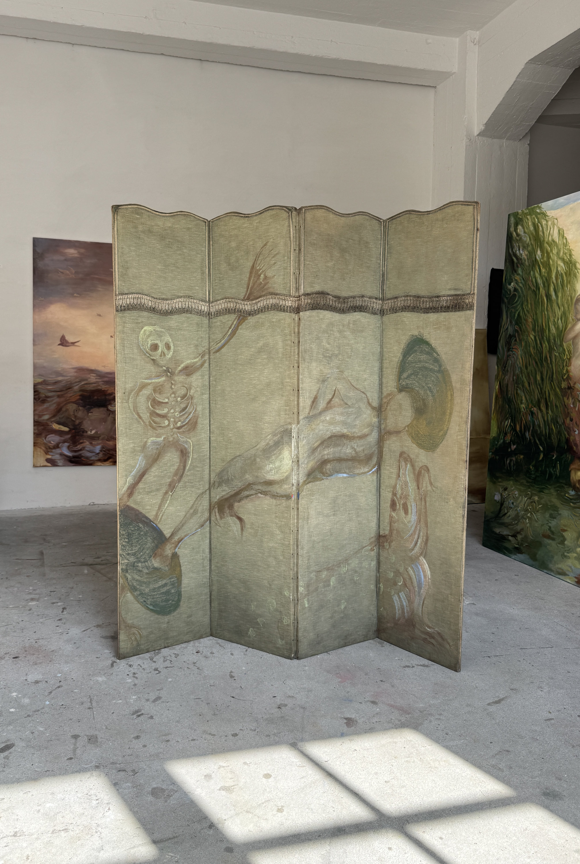 A painted paravane with 4 panels by the Berlin-based Swedish painter Emeli Theander, standing in her Berlin studio.